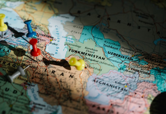 Colorful pushpins marking locations on a detailed map of Central Asia